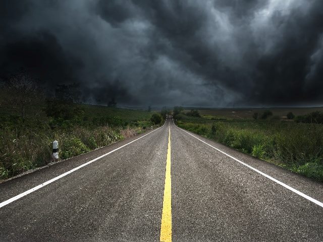 Empty road with gloomy forecast above. 