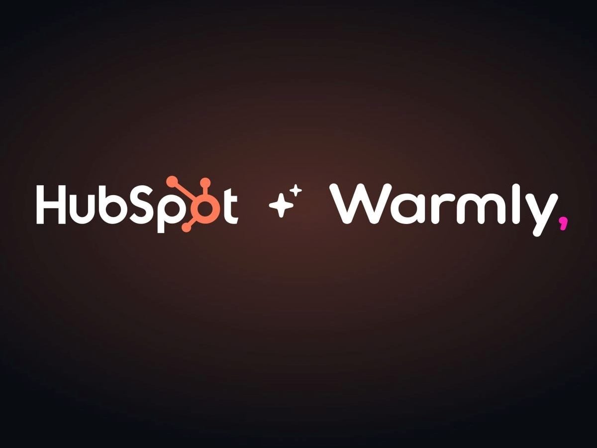 A promotional graphic displays the HubSpot and Warmly logos side by side on a dark gradient background, highlighting a partnership or integration between the CRM platform and the AI-powered sales engagement company.