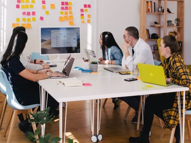A marketing team brainstorming how to respond to an online review given by an unhappy customer