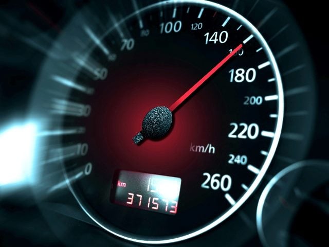 The speedometer of a modern car shows a high driving speed with white numbers and a red needle in piece about sustainable website design and speed. 