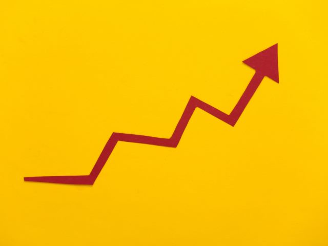 red growth arrow on a yellow background