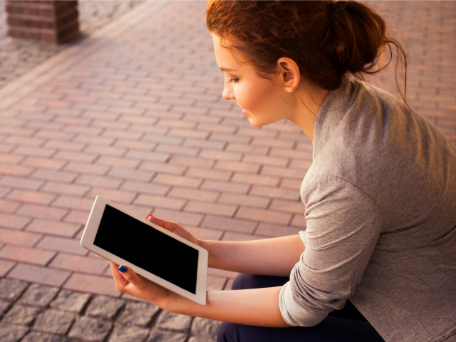 woman reading her tablet