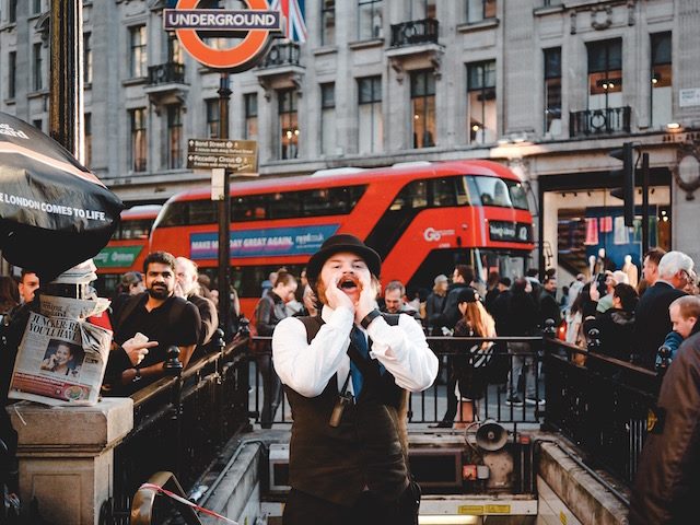 man yelling on public street in London