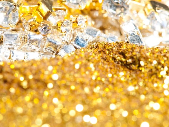 Gold pieces and crystal pieces in a close-up view.