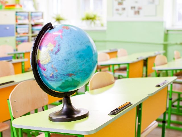 Earth globe on the yellow desk at classroom, representing a planet that may be hurt unless you have sustainable website design.