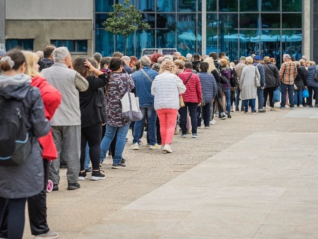 Long queue of customers on street. 