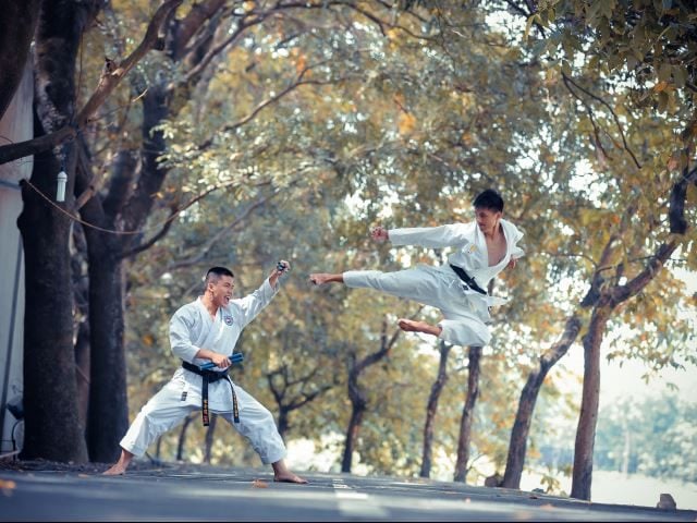 Two karate fighters facing off in an outdoor park - Kanban vs Gantt Charts concept