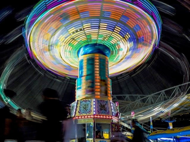 carnival  ride  at night, tilting on  its axis