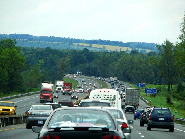 Line of cars in traffic on a highway, shot from behind the line.