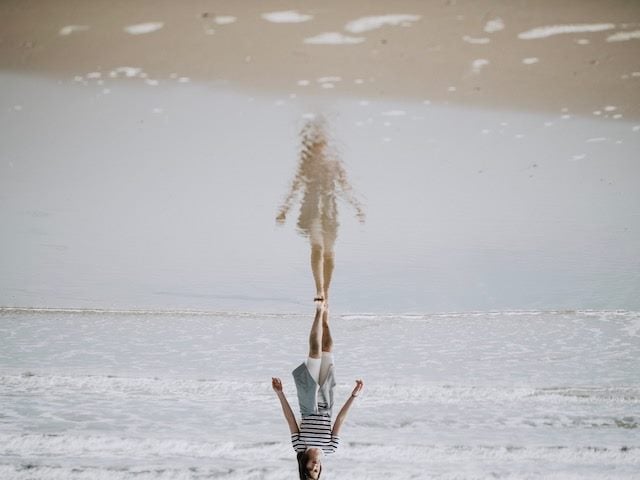 reflection flipped upside down/optical illusion of person walking on sand 