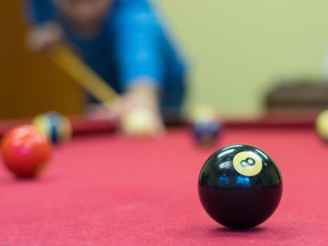shooting for the eight ball on a pool table