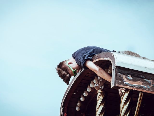 man on a roof adjusting something in the building