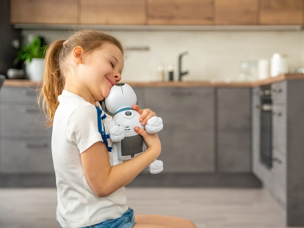 Child hugging robotic dog.