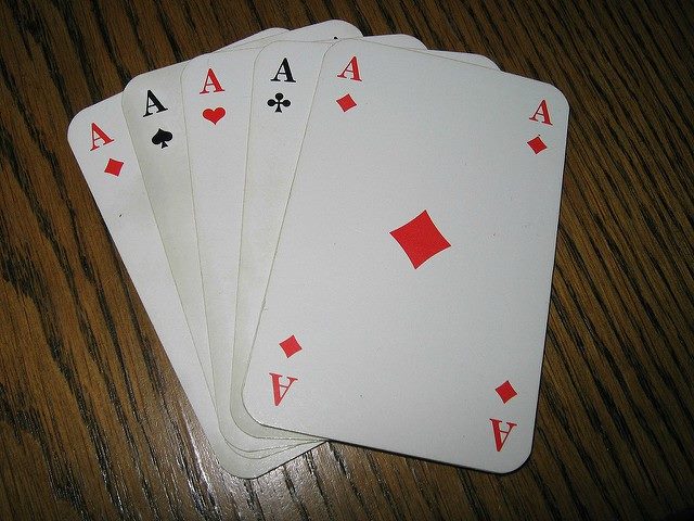 A row of Ace cards laid out on a table.
