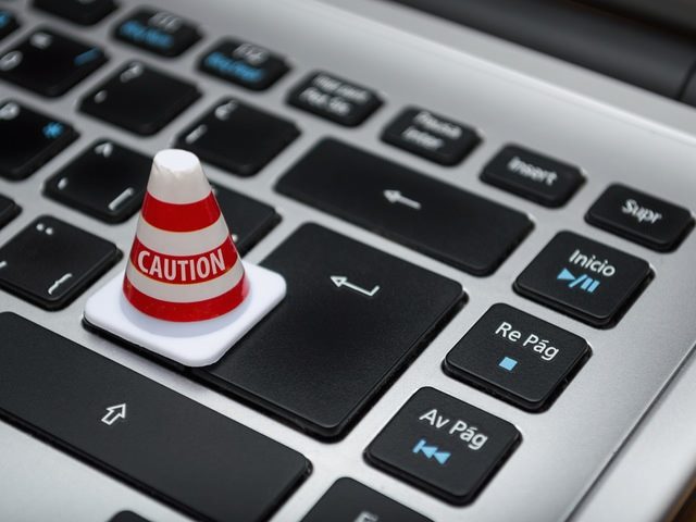 caution sign on a computer keyboard