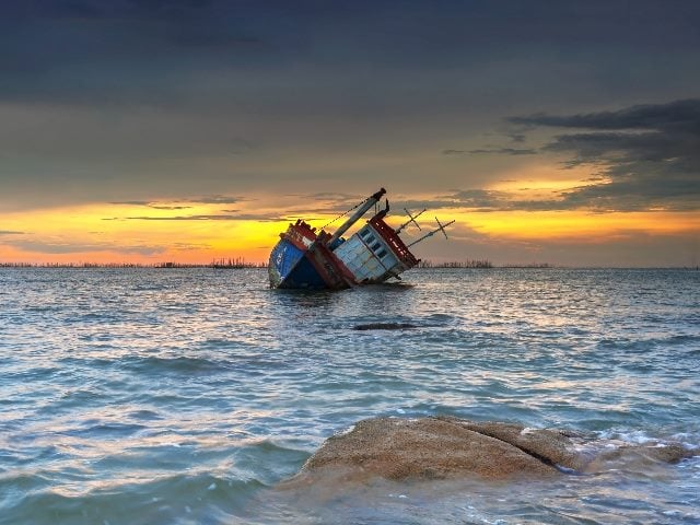 Ship wrecked boat at sunset in Chonburi, Thailand. 