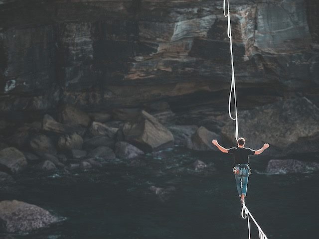 person walking on a tightrope