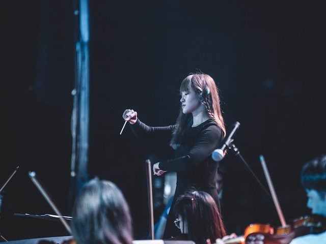 conductor leading an orchestra
