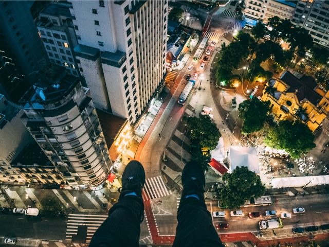 feet dangling from a skyscraper