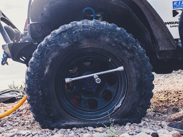flat tire with a tire iron in it