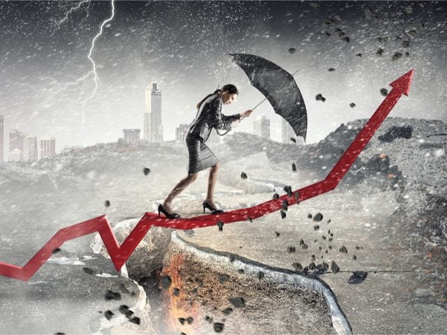 A marketing businesswoman overcoming challenges and crisis through a storm destruction walking up a positive trend line - Marketing Challenges Concept