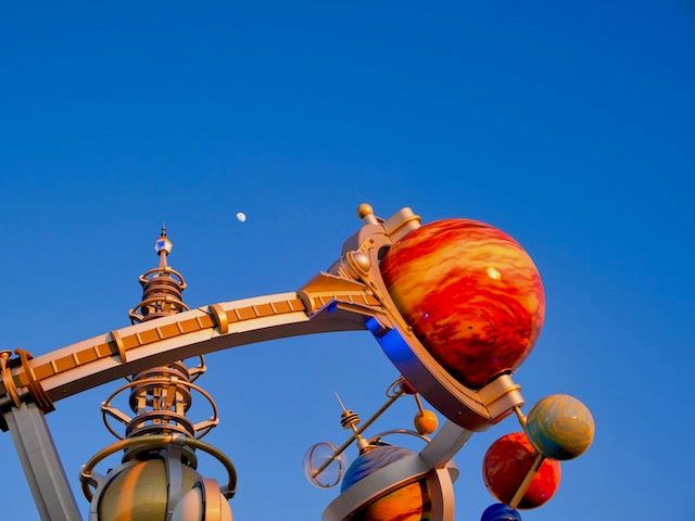 planet sculpture with real moon in the background