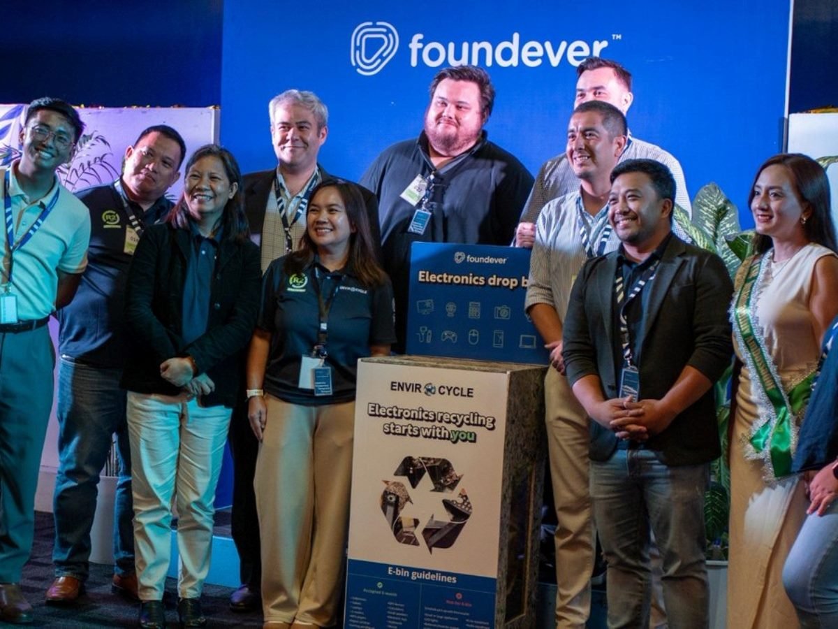 A team of Foundever employees in July at a booth for the company at a conference.
