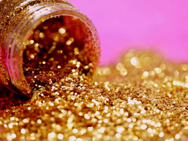 canister of gold glitter tipped on its side