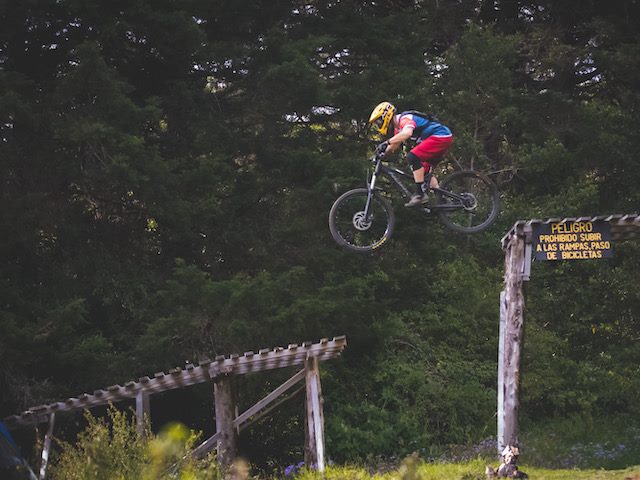 bicyclist jumping off  a ramp in mid-air