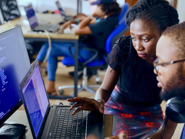 two colleagues looking at a computer screen together