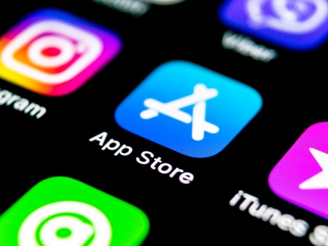 Closeup of Apple's  App Store application icon on Apple iPhone with partial icons of iTune and Instagram and others visible. 