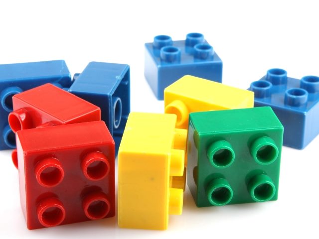 Nine scattered square Lego-like snap together composable piece toys.
