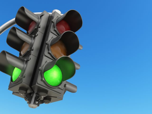 traffic light with green color on blue sky background