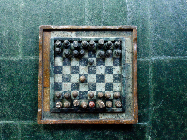 A chessboard on green surface - Strategy Concept