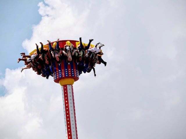 amusement park ride with people hanging upside down in the air