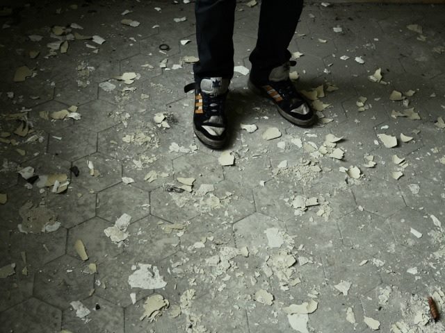person standing on scattered bits of paper