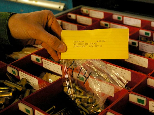man holding kanban card with benchstock items attached