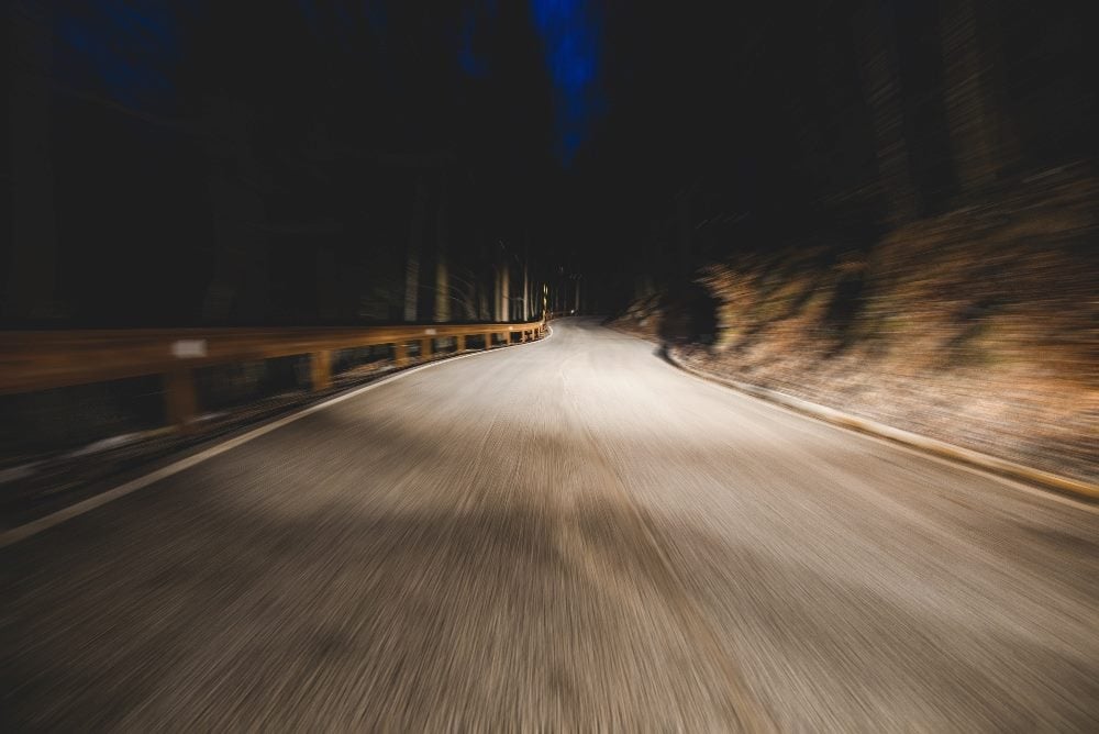 Headlights on a mountain road illuminate the path forward in piece about marketing leadership strategies for CMOs.