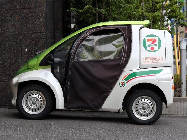 A Toyota 7-Eleven convenience store's electric delivery vehicle behind a store in Chiba City.