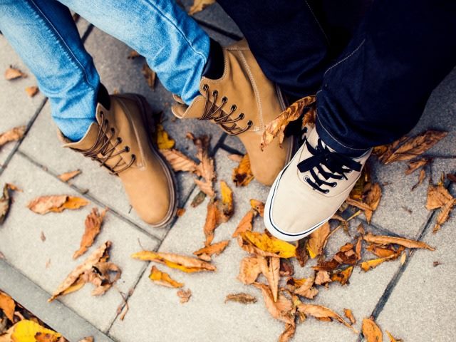 two people feet intertwined 