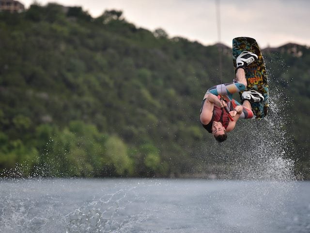 water skier flipping upside down on a lake