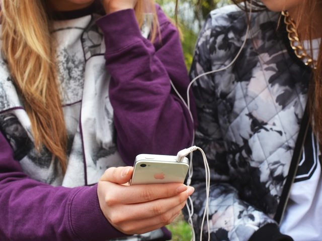 two people sharing an iPhone