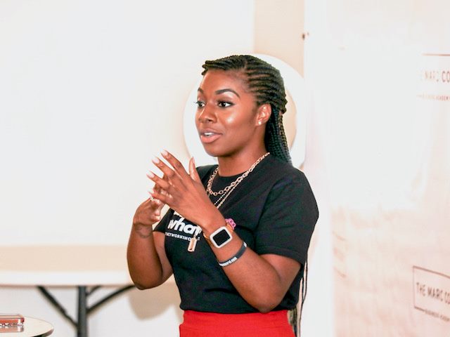 woman speaking  in front of a group