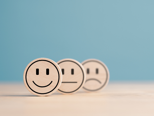 Wooden label with happy normal and sad face icons