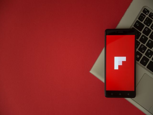 Mobile phone with Flipboard logo on top of a computer keyboard