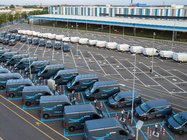 Top view of Amazon Prime electric delivery vans, parked at the logistics hub of Amazon in Turin, Italy. Amazon Prime serves as a prime example of customer obsession. 