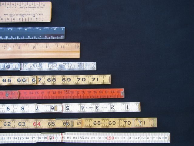 Rulers and scales in metric and inches representing business analytics, measurement, accuracy and results