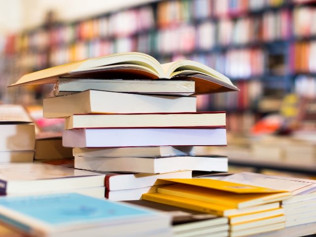  Stack of books lying on table in bookstore.