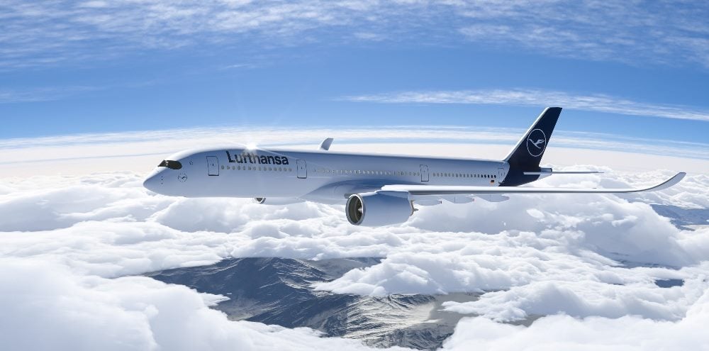 Lufthansa commercial Aeroplane flying in the sky above the mountains.