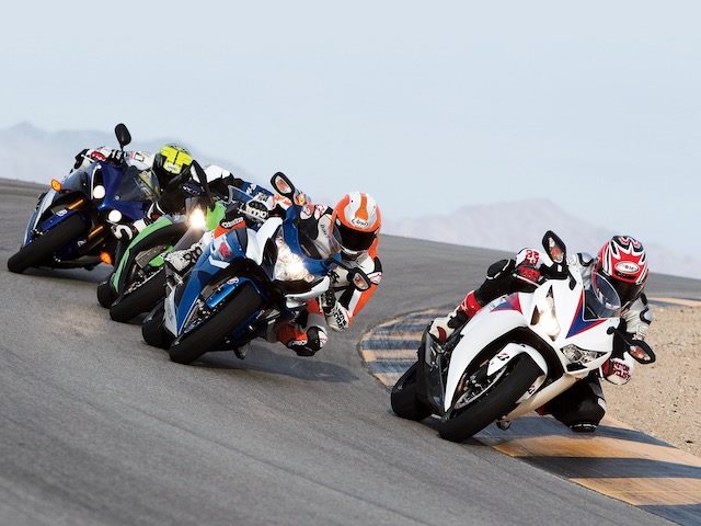 four motorcyclists racing around a curve
